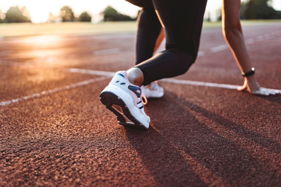 Runner at track starting line in early morning