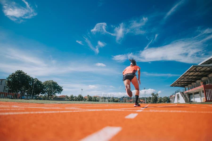 Athlete running on an all-weather running track