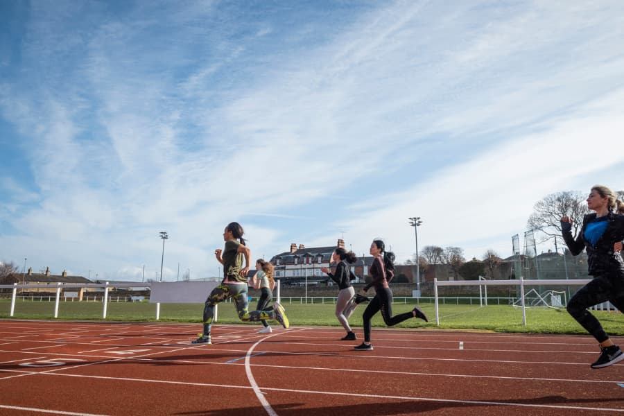 Competitors run on high school track