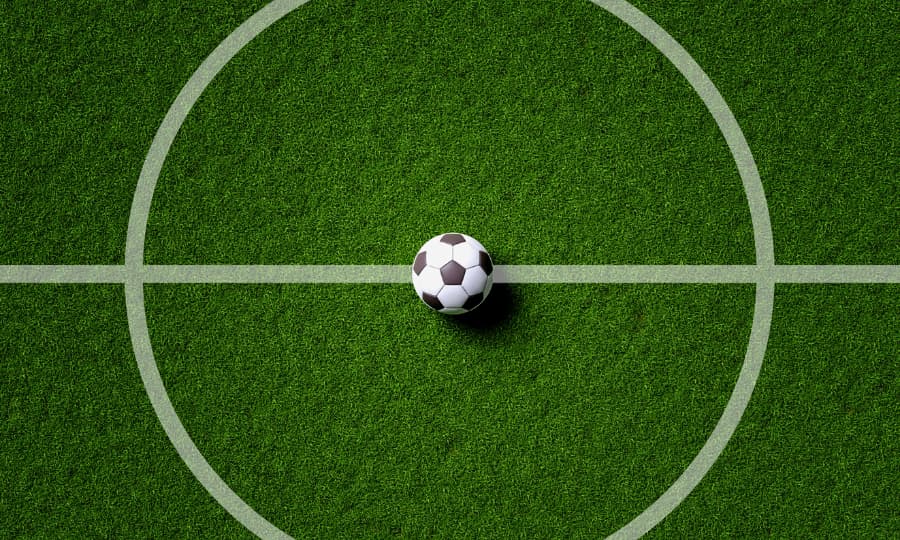 Soccer ball in center of turf field